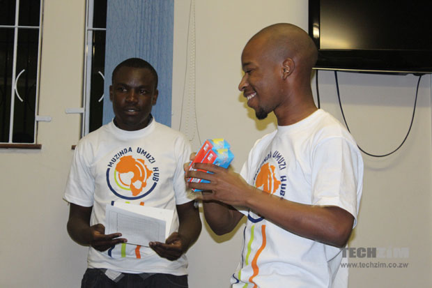 An iDzidzo team member, Jabulani Mpofu receives a prize at the Hackathon