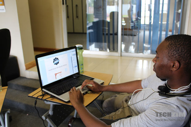Shepherd Chabata, who was doing graphics work for iDzodzo, works at his machine.