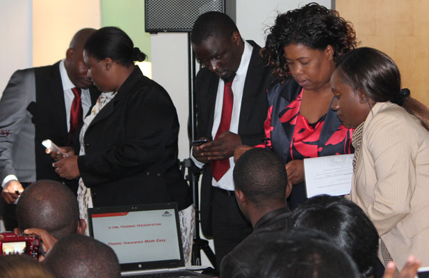 Invited guests testing the new e-FML mobile insurance product from First Mutual Life