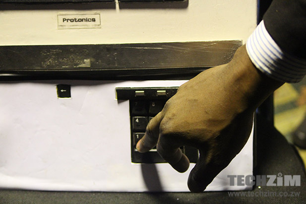 An audience member enters his phone number on the Protronics airtime vending machine prototype