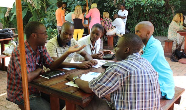 A team at the CultureShift Zimbabwe Ideation event discusses a book distribution solution for writers in Zimbabwe