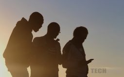 silhouette of men on mobile phones