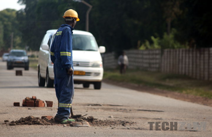 Man fixing road voluntarily in Harare