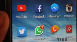 Phone screen showing various social media apps, WhatsApp included