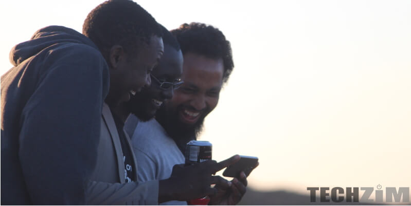 Men staring at a phone, Zero-rate, techzim